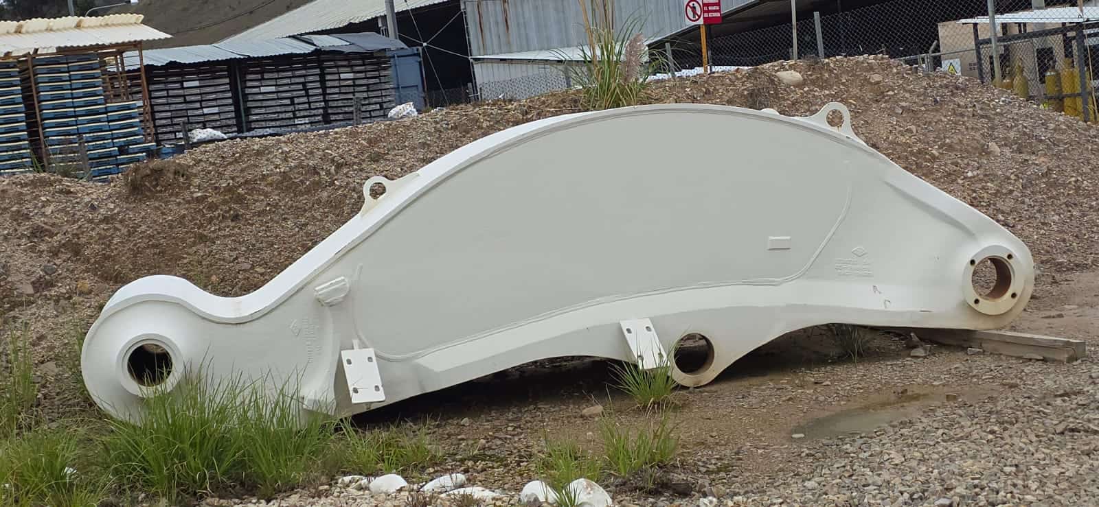 Heavy-duty O&K RH90 excavator component on construction site.